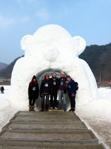 The gang inside a giant snow bear's mouth.